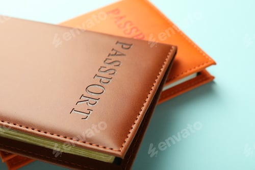 Preview: Passports in color covers on light blue background, closeup