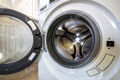 Preview: Close-up detail of modern washing machine interior with open door interior. Silver shiny stainless