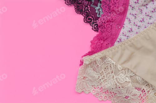 Preview: White, black and pink women underwear with lace on pink background close up with copy space