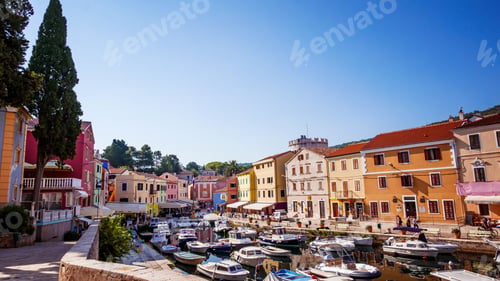 Preview: Old seaside town with picturesque colorful houses around a bay with boats.