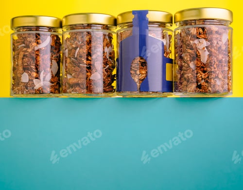 Preview: Glass jars with granola and coconut flakes on colorful background