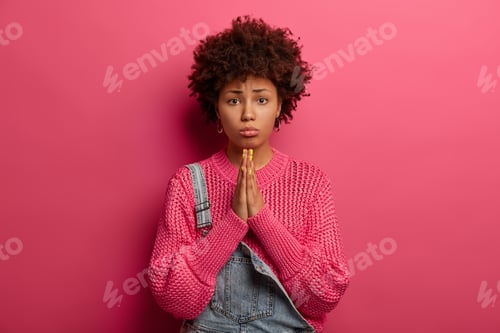 Preview: Regretful dark skinned African American woman beggs for forgiveness, feels guilty, purses lower lip,
