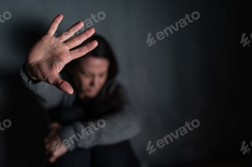 Preview: Depressed mid-adult woman, alone in darkness, stop the war concept
