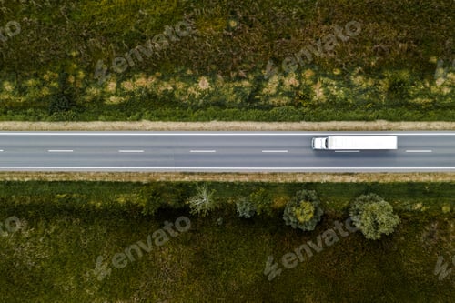 Preview: Large freight transporter semi-truck on the road, aerial view