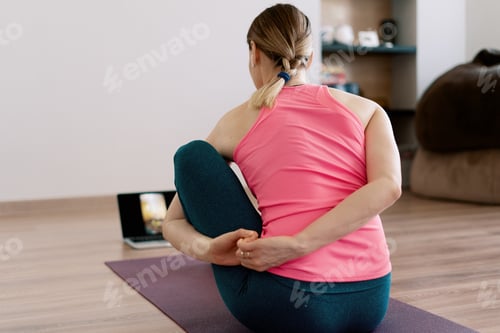 Preview: Authentic woman practicing yoga at home