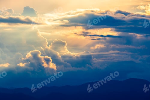 Preview: Golden Light Through the Clouds Over Mountains