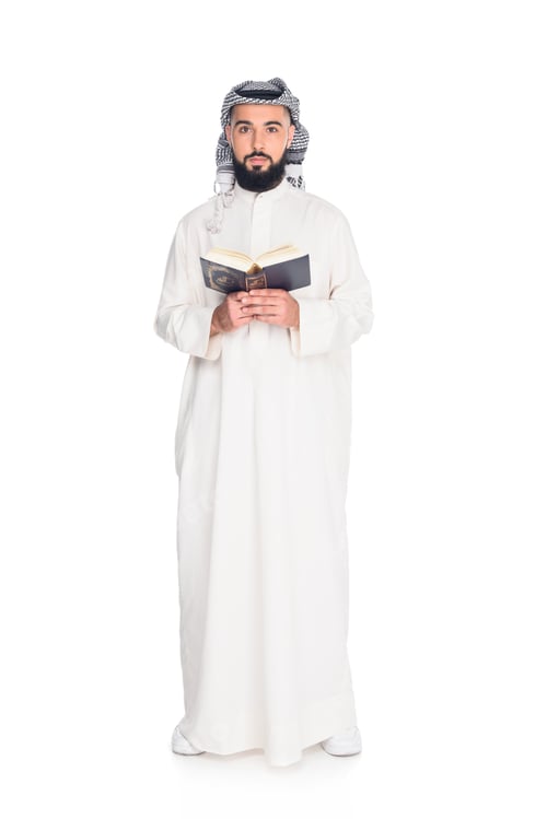 Preview: young muslim man reading quran isolated on white