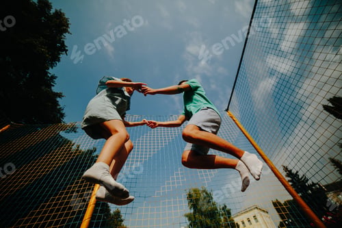 Preview: Couple jumping on trampoline in the park