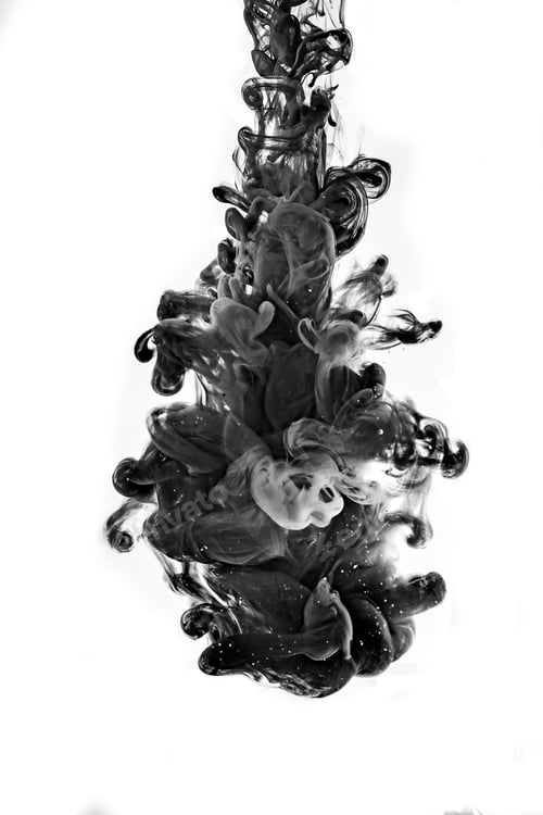 Preview: Black ink falling in the water on white background.