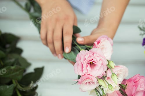 Preview: Female florist making beautiful bouquet at flower shop