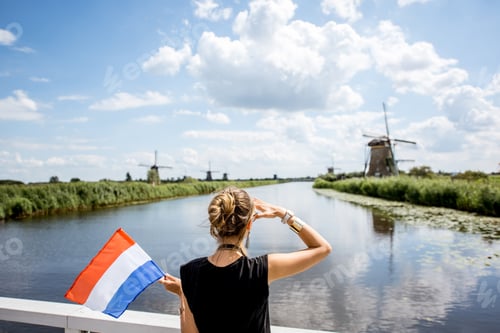 Preview: Woman near the old windmills in Netherlands