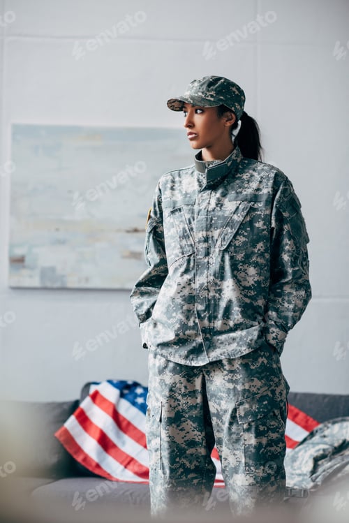 Preview: african american female soldier in military uniform with american flag on background