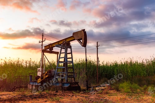 Preview: Oil rig pump against a colorful sunset sky