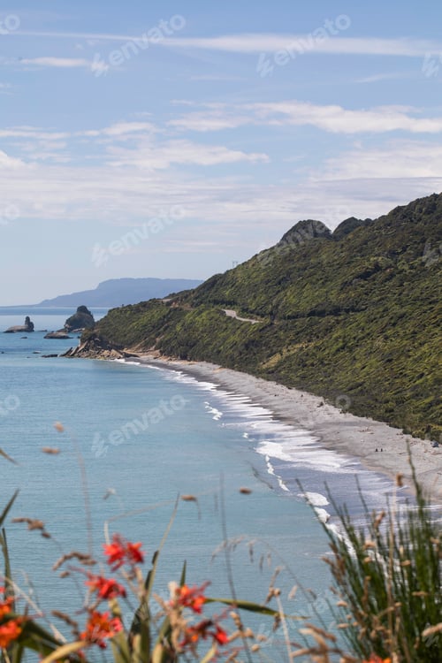 Preview: Dramatic coastal landscape with rugged cliffs and pristine beach on a clear day