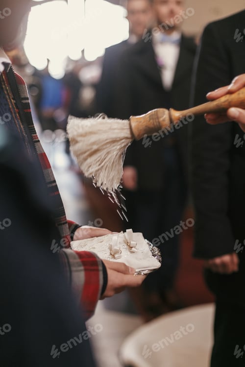 Preview: priest blessing with holy water white silk pillow with wedding rings