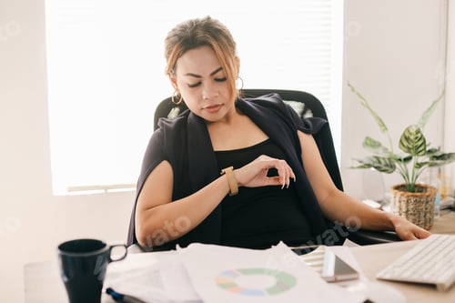 Preview: Woman Checks Her Watch at the Office