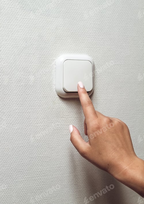 Preview: Female hand turns off the light indoors. Electrical energy savin