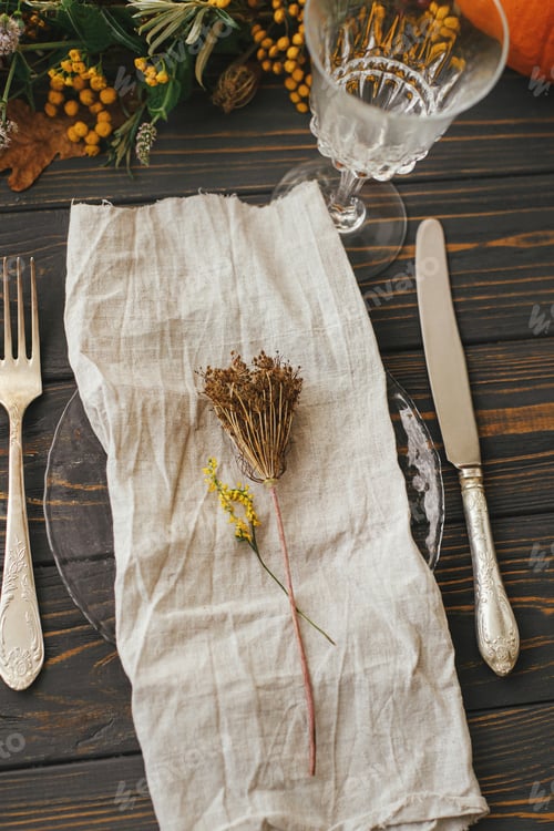 Preview: Modern plate with cutlery, linen napkin, herb on table with pumpkins, autumn flowers arrangement