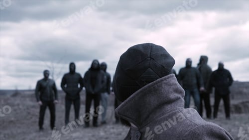 Preview: Man sits in a chair and looks at a group of masked criminals. Footage. A meeting place for gangsters