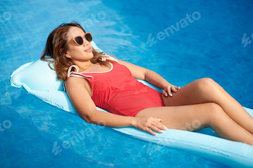 Preview: Woman Sunbathing on Inflatable Mattress