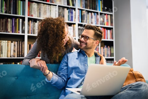 Preview: Young happy couple with laptop at home