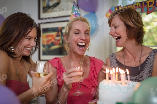 Preview: Three mature women at birthday party, laughing