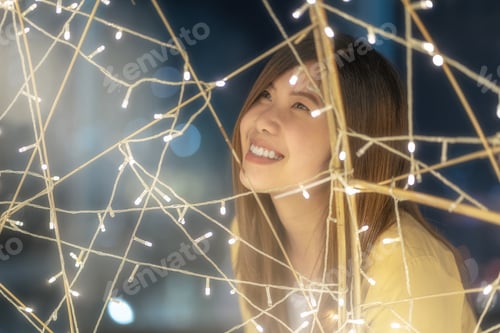 Preview: Closeup Portrait of asian woman with light at night, merry christmas and new year celebration