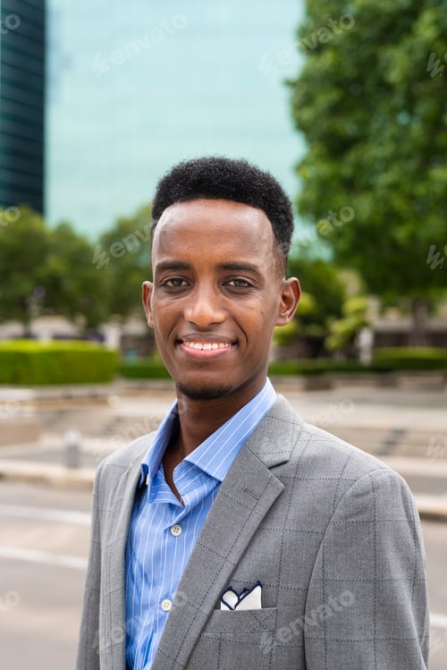 Preview: Portrait of handsome young black man outdoors in city