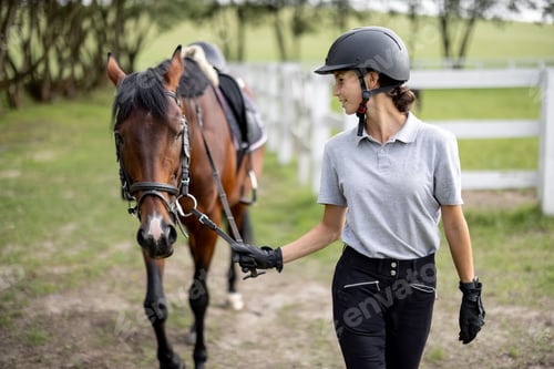 Preview: Female horseman go on lawn with Thoroughbred horse