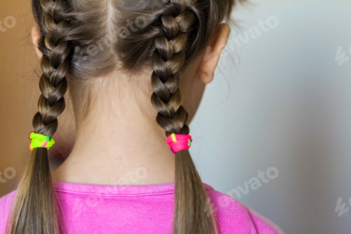 Preview: Close up portrait of a cute little girl with funny pigtails