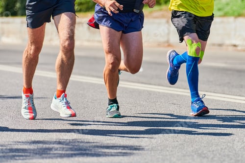 Preview: Athletes running down road, low angle view