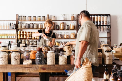 Preview: Man and Woman Purchasing Bulk Food Items at a Sustainable Grocery Store