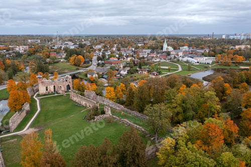 Preview: Aerial view of historic ruins and colorful autumn foliage in a small town