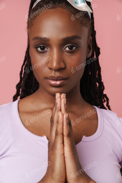 Preview: Young black woman with afro pigtails looking at camera and gesturing