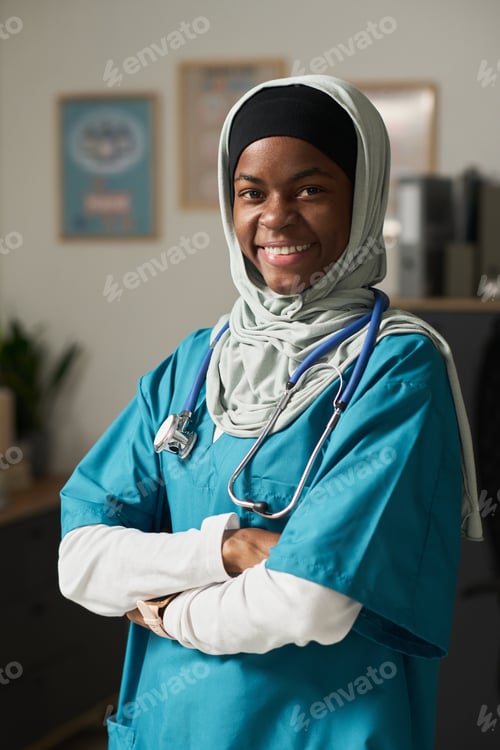 Preview: Smiling Muslim Nurse Wearing Scrubs in Medical Office