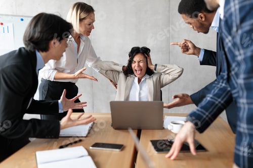 Preview: Unhappy Businesswoman Screaming While Coworkers Shouting At Her In Office