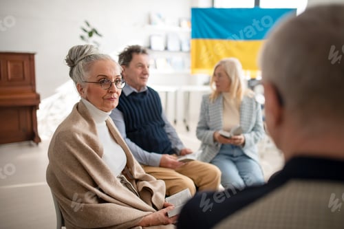 Preview: Group of seniors praying for Ukraine together in church community center