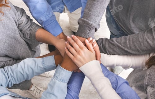 Preview: Joined hands in stack of unrecognizable people, closeup