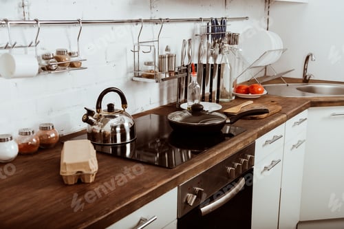 Preview: modern kitchen interior with frying pan and teapot on stove