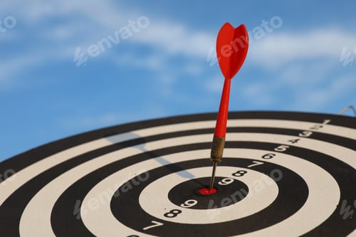 Preview: Targeting. Dart board with arrow against blue sky, closeup