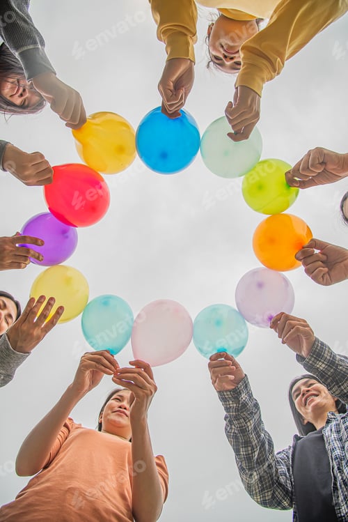Preview: diversity group of people held colorful balloons to show unity and solidarity