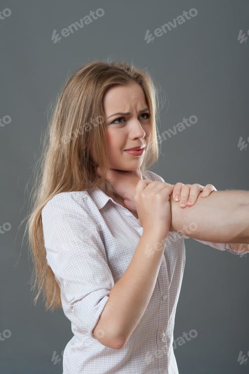 Preview: Poor Young Fair-Haired Woman Looking Pained At The Man Stifling Her. Isolated On Grey Background