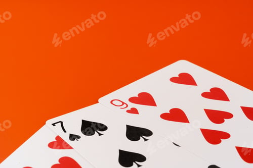 Preview: Playing cards on paper background close up