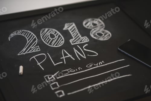 Preview: 2018 plans written on a chalkboard, with join gym as one of the listed plans