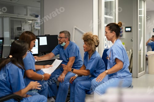 Preview: Diverse medical team collaborating on patient data in hospital