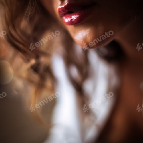 Preview: Studio portrait of a beautiful girl in a strict business suit with an unbuttoned shirt, close-up