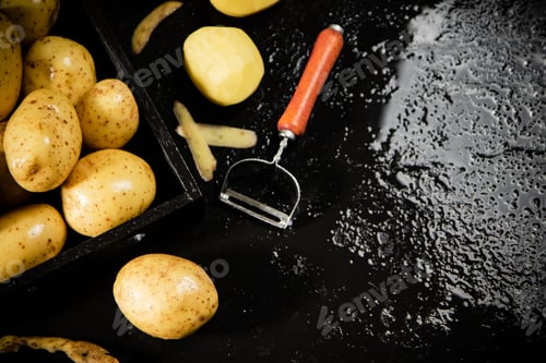 Preview: Fresh potatoes. On black background.