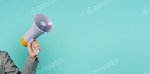 Preview: Hand is hold megaphone and wear grey suit on green or mint or Tiffany Blue background.