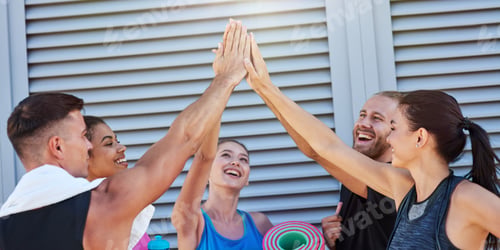Preview: Happy mixed race sport team giving high five near wall