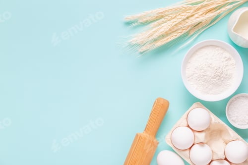 Preview: Ingredients for baking on light blue background.